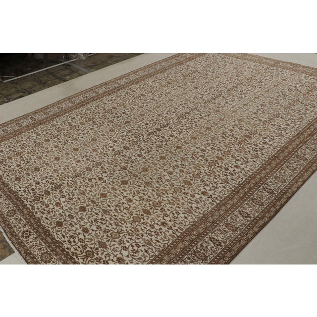 Hand-knotted in wool, this 8x12 vintage Sivas rug, circa 1950-1960, features intricate Herati patterns in rich browns all...