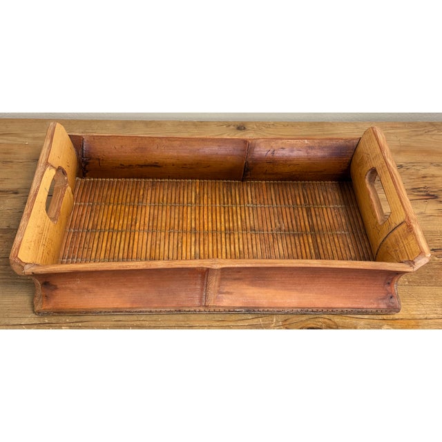 Vintage split reed tray with heavy bamboo sides. Holes cut for handles. Practical and functional. Rich patina to bamboo....