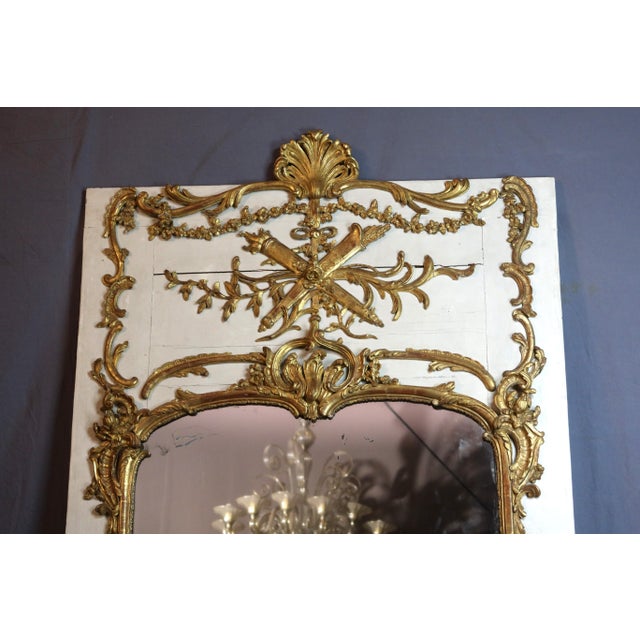 Large Louis XV trumeau mirror, 18th century, in painted and gilded wood with a large shell motif on the upper section. The...