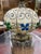 This sculptural fiberglass resin table lamp features a hand-decorated globular body with silver scrollwork, blue and green...