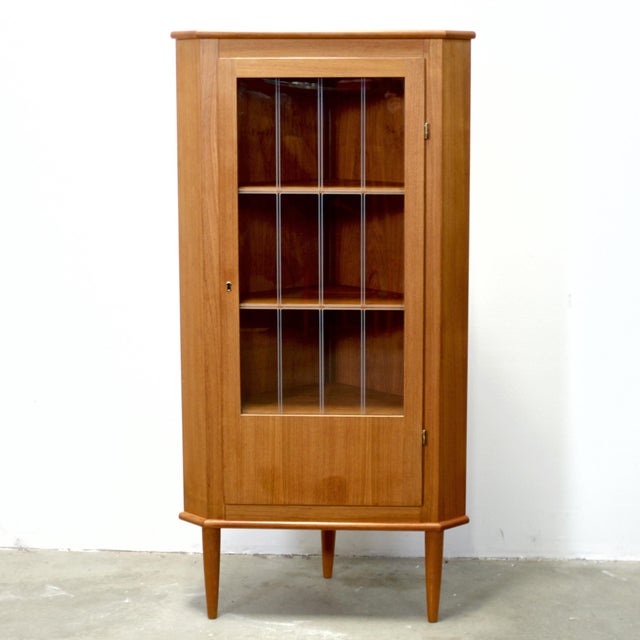 Dimensions: 28 1/2” L x 20 1/4” D (wall side) x 56 3/4” H / 17 1/2” D door to corner Origin: Denmark Designer: Unknown...