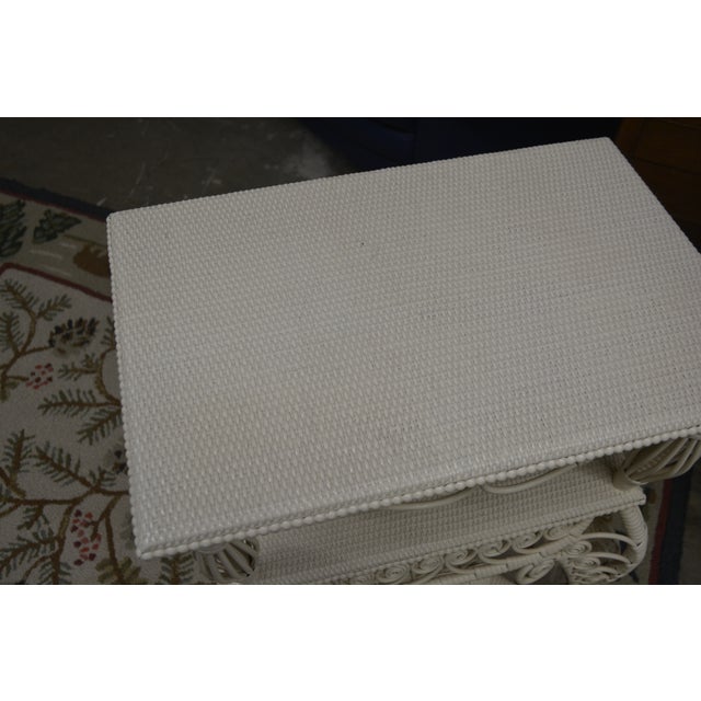 This is the cutest shelf! Very solid, sturdy, & well made. Appears to be wood & wicker, all very firm, with the fiddlehead...