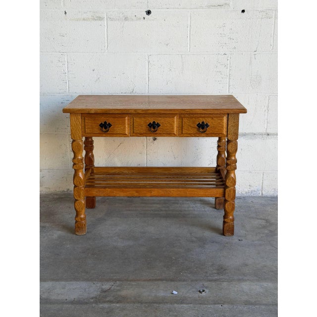This small oak hallway table in style of Henning Kjærnulf combines three drawers with a slatted lower shelf. Sculpted legs...