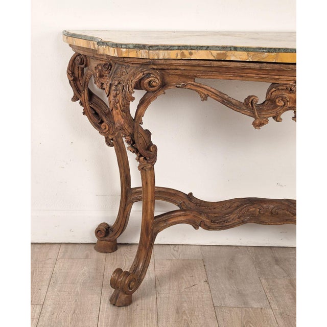 An 18th-century Italian walnut rococo console with Giallo Siena marble top edged with Verde Antico marble.