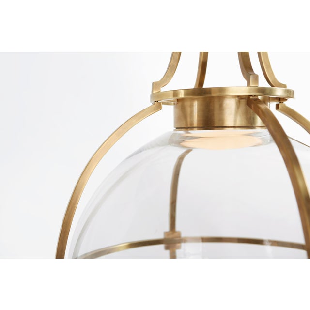 Gracie Large Captured Globe Pendant in Antique-Burnished Brass with Clear Glass Designer: Chapman & Myers Canopy: 5.25"...