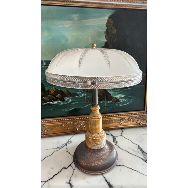 A striking Art Deco table lamp featuring a substantial frosted molded glass dome shade atop a beautifully proportioned...