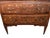 Neoclassical commode hand-made in Italy in the early 1800s using walnut and decorated with walnut cross-banded veneer. The...