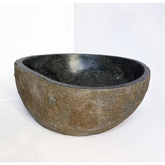 A stone bowl with a polished basin. Indonesia, contemporary Can also be used as a decorative bowl or planter. Rough stone...