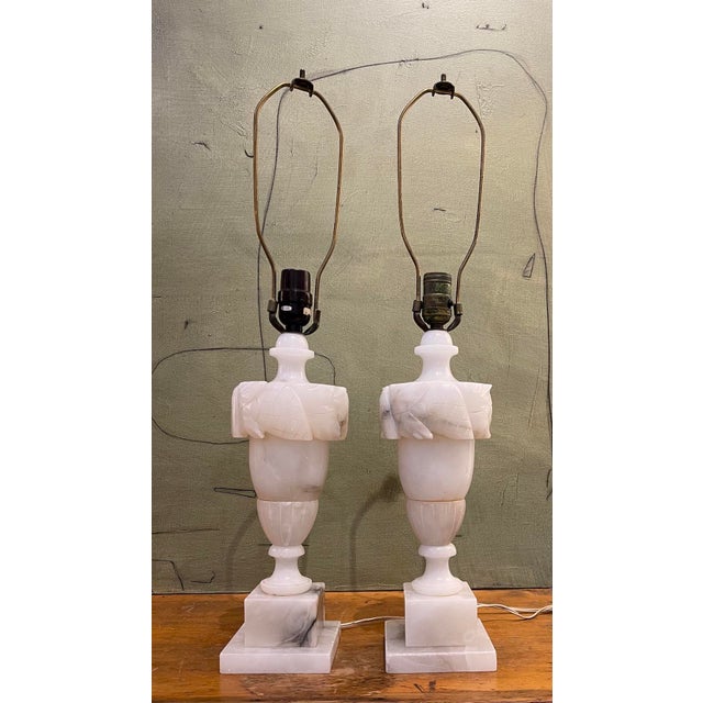Pair of Italian carved alabaster table lamps with elegant neoclassical styling, dating to the early 20th century. These...
