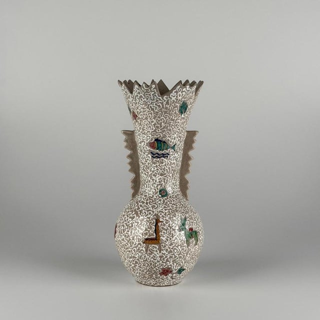Expressive and richly decorative, this ceramic vase embodies the lively spirit of mid-century italian artistic production,...