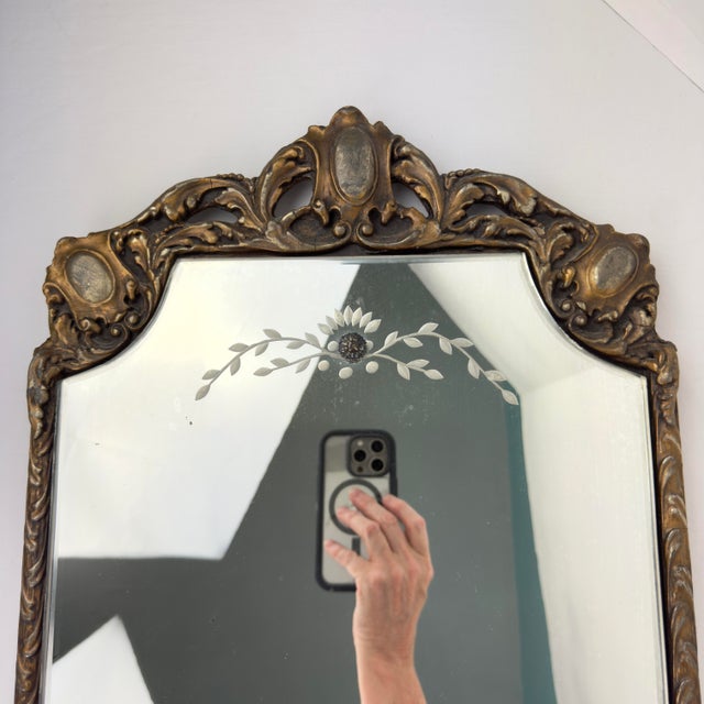 This is a beautiful vintage wood and gesso wall mirror featuring an ornate leaf and medallion motif across the crown and...