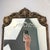 This is a beautiful vintage wood and gesso wall mirror featuring an ornate leaf and medallion motif across the crown and...
