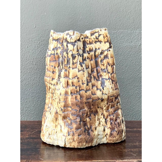 This vintage handcrafted ceramic vase is a striking example of organic studio pottery, distinguished by its sculptural...