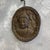 Brown Carved Wooden Wall Amulet Depicting the Buddha in the Gandhara Style with Om Symbol on the Back, 20th Century For Sale - Image 8 of 12