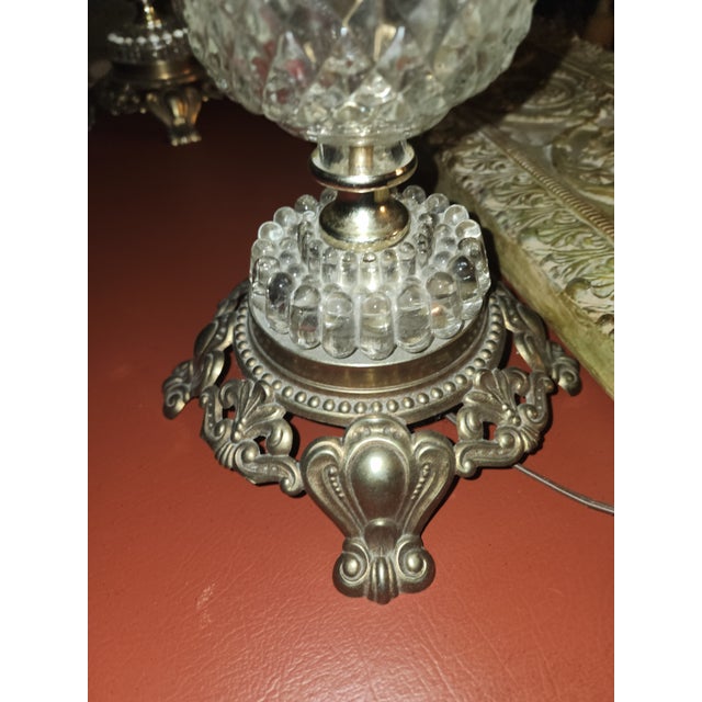 ​A striking pair of vintage mid-century table lamps, dated 1967. These lamps feature a heavy, clear pressed glass body...