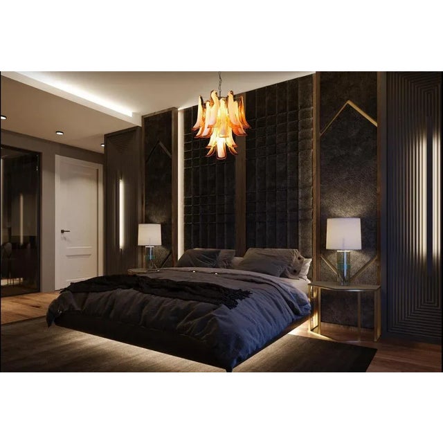 Italian vintage Murano chandelier made by 26 glass petals (amber and white “lattimo”) in a chrome frame. Period: 1980's....