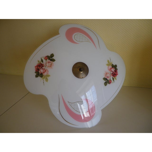 Free-form pendant light in rhodoid, with floral silkscreen prints (roses) and integrated graphic motifs (commas, roses...