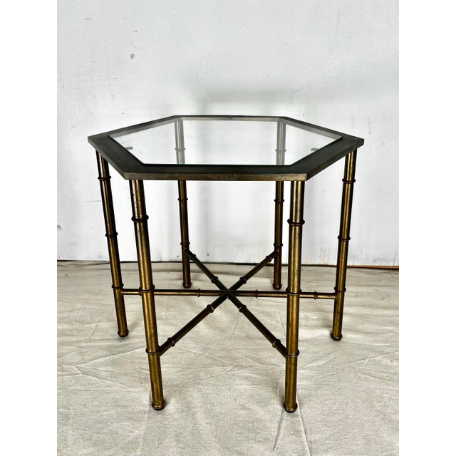 Vintage solid brass hexagonal side table. Faux bamboo style legs with hexagonal top and glass insert. Attributed to...