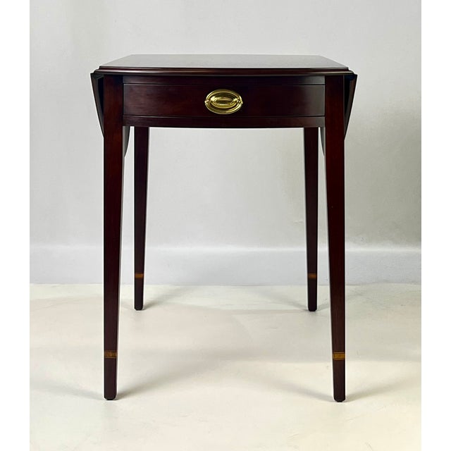 This finely crafted Pembroke drop-leaf table by Henkel Harris features a classic Federal-style design constructed from...