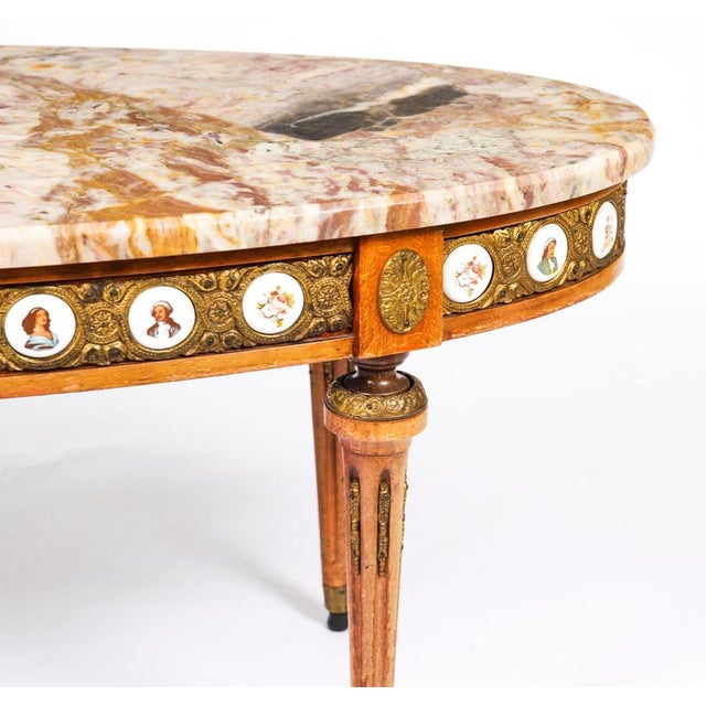 This is an exquisite French giltwood and marble top coffee table with Limoges plaques, circa 1950 in date. This wonderful...