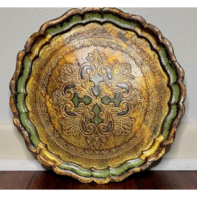 Elegant vintage Florentine tray, handcrafted in Italy and finished in a rich gilt tone with soft green accents. This round...