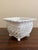 An elegant trompe l'oeil porcelain cachepot crafted in the form of a handwoven rope basket. Executed in glossy white...
