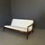 Sixties sofa, Italian manufacturing. The sofa has a simple and light brown teak wood structure, reminiscent of the Danish...