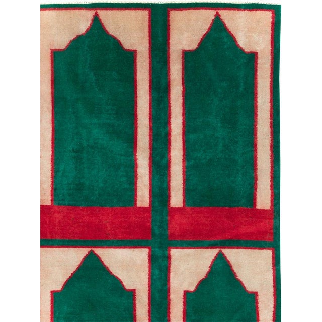 This Mid-20th century Turkish Art Deco style small room-size carpet presents a bold, structured composition arranged in...