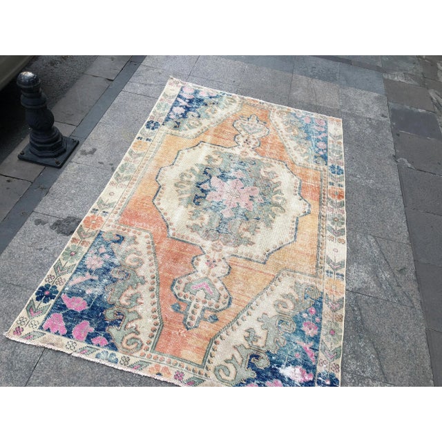 This is a vintage Turkish Oushak rug from the 1960s. The piece was hand-knotted using wool.