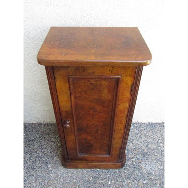 Antique French burl walnut nightstand, c.1900 Having a rectangular top below which is a paneled cupboard door and standing...