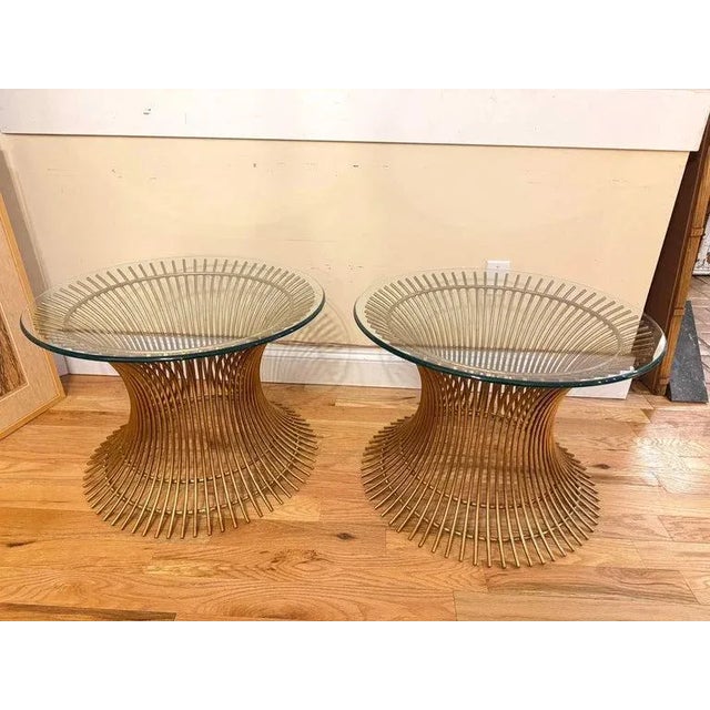 Pair of Mid-Century Modern Warren Platner style tables. This is a rare pair of gold gilt end tables featuring an...