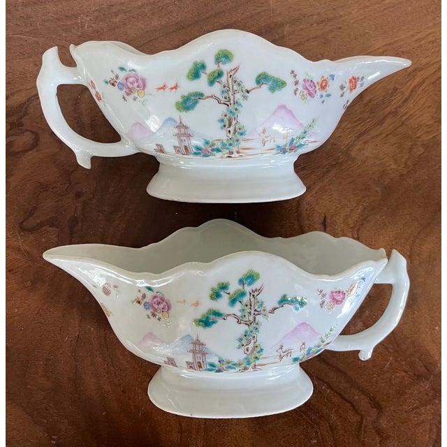 Pair antique 18th century Chinese export Qianlong porcelain sauce boats in famille rose glaze. Decorated with trees and...