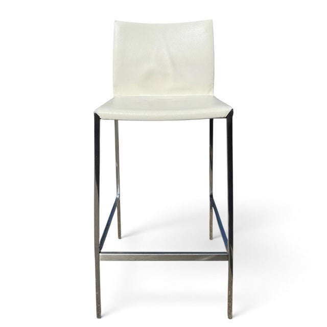 A set of four stools designed by Roberto Barbieri for Zanotta. The Lio stool is upholstered in a full-grain white Italian...