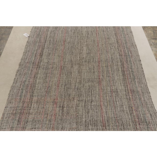 Connoting minimalist midcentury aesthetics, a vintage kilim rug from our flatweave selections. Originating from Turkey,...