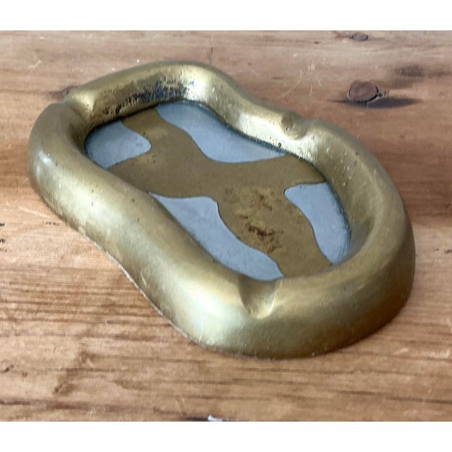This striking asymmetrical ashtray is a signature design by the renowned Scottish-Spanish designer David Marshall....