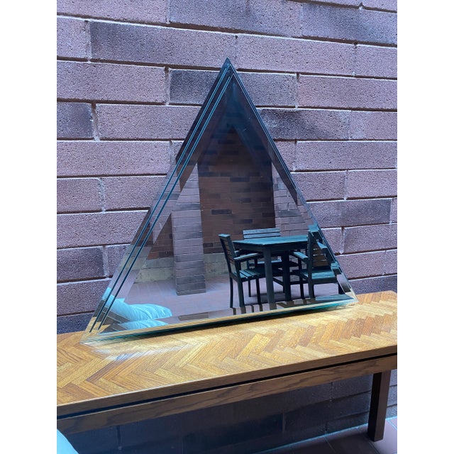 Large beveled triangle shaped three layer mirror from 1989. Excellent condition and features the ability to be hung on the...
