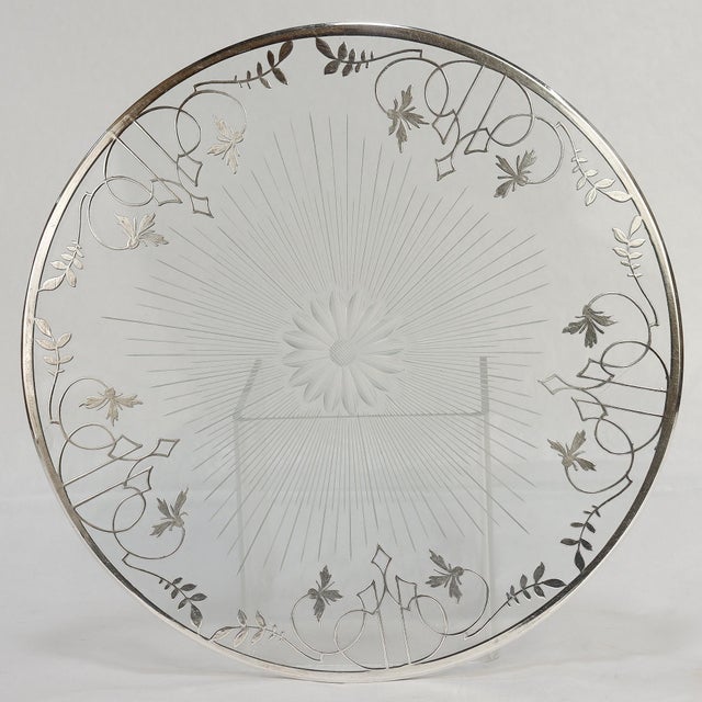 A fine antique Table coaster or trivet. With sterling silver overlay on a glass base. With a cut flower pontil to the...