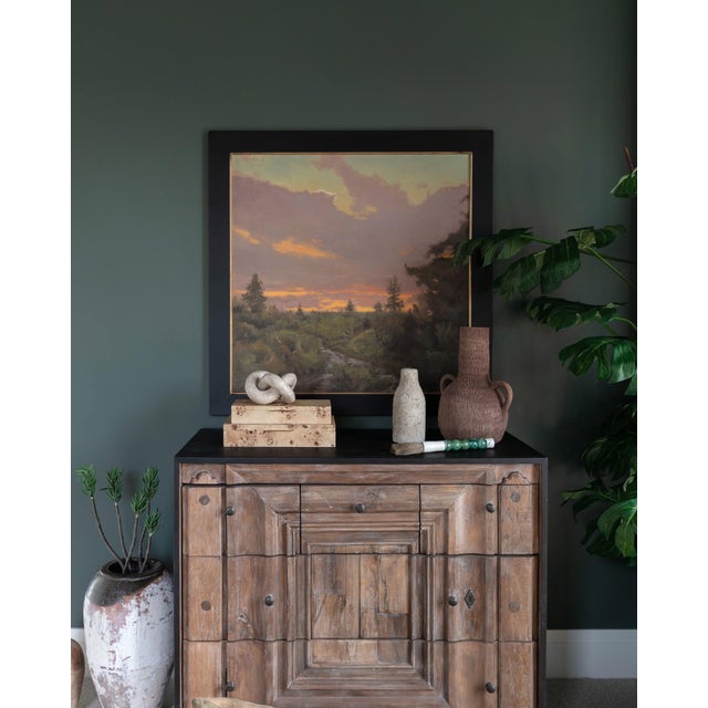 The painting captures a serene landscape at dusk, where soft hues of pink, orange, and lavender blend seamlessly in the...