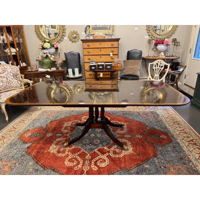 This is a 1940s Beacon Hill single pedestal table. It is mahogany with satin band. It is on brass castors. The dimensions...