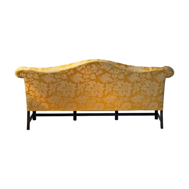Vintage 'Charles Stewart Company' Chippendale style camelback sofa with Damask upholstery and carved front legs.