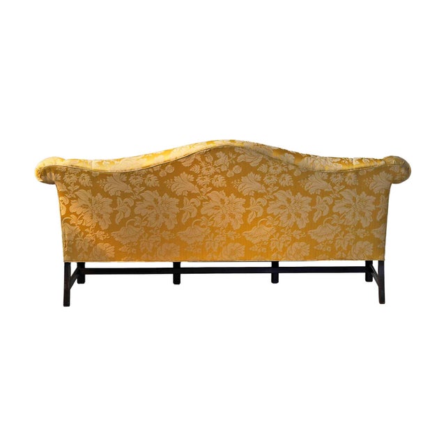 Vintage Charles Stewart Company Chippendale style camelback sofa with Damask upholstery and carved front legs.