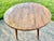 Vintage (1950's) Round Drop Leaf Table has an Americana Style. Made by Ethan Allen. The Wood is Maple. The Table's Legs...
