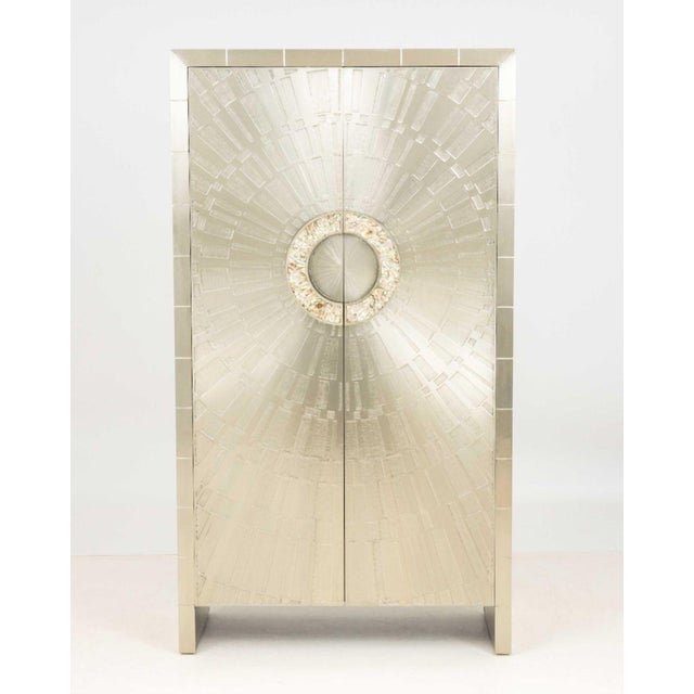 Jonathan Adler "Talitha" Armoire, with starburst pattern nickel-plated metal exterior, the two doors with abalone shell...