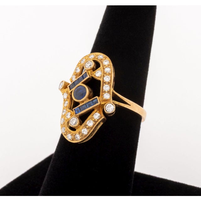14K Yellow Gold Diamond Sapphire Ring, featuring twenty six pave set round brilliant cut diamonds weighing a total of...