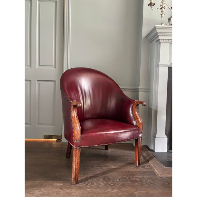 Beautiful, antique rich burgundy colored leather tub chair with nailhead detailing throughout. Wear is consistent with age...