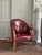 Beautiful, antique rich burgundy colored leather tub chair with nailhead detailing throughout. Wear is consistent with age...