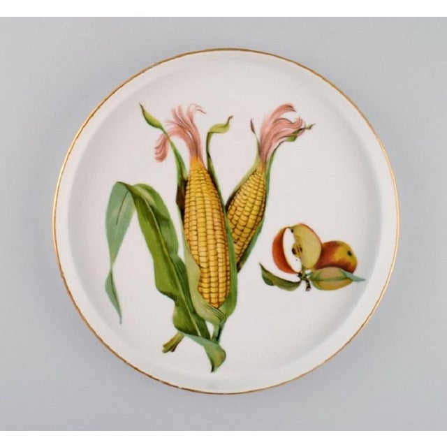 Royal Worcester, England. Six round porcelain dishes decorated with corn cobs, apples and gold edge. 1960s. Measures: 21.5...
