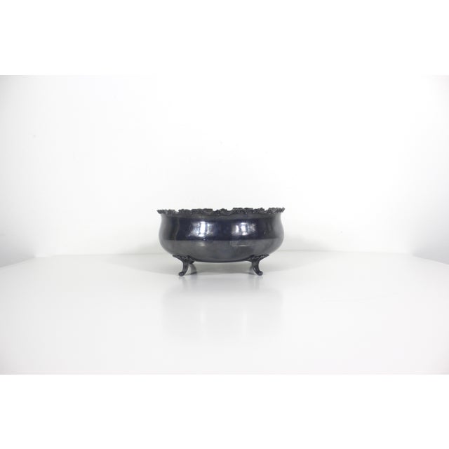 Stunning, footed silver plate centrepiece bowl with a detailed edge and four fan shaped feet. This has nearly black...