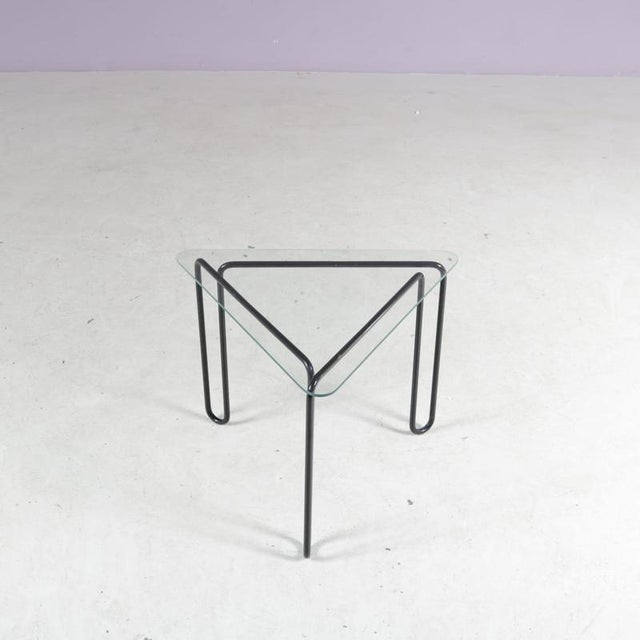 A lovely side table, manufactured in the Netherlands around 1980. This elegant little piece is made of black lacquered...