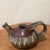 Crafted with the care of masters, this vintage Asian wood-fired glazed stoneware teapot is a testament to traditional...